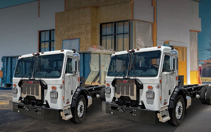 Two Peterbilt Model 520 trucks next to each other