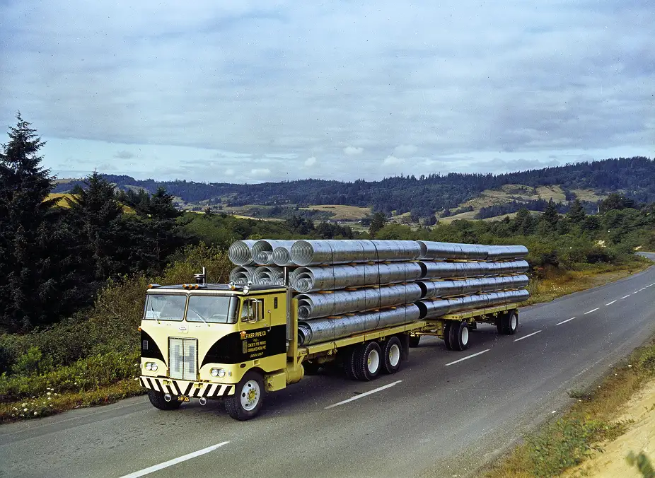 Peterbilt Model 352 hauling piping
