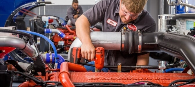 Rush Truck Centers technician working on Cummins engine