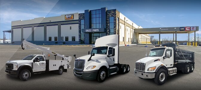 Line up of used trucks in front of Rush Truck Centers dealership