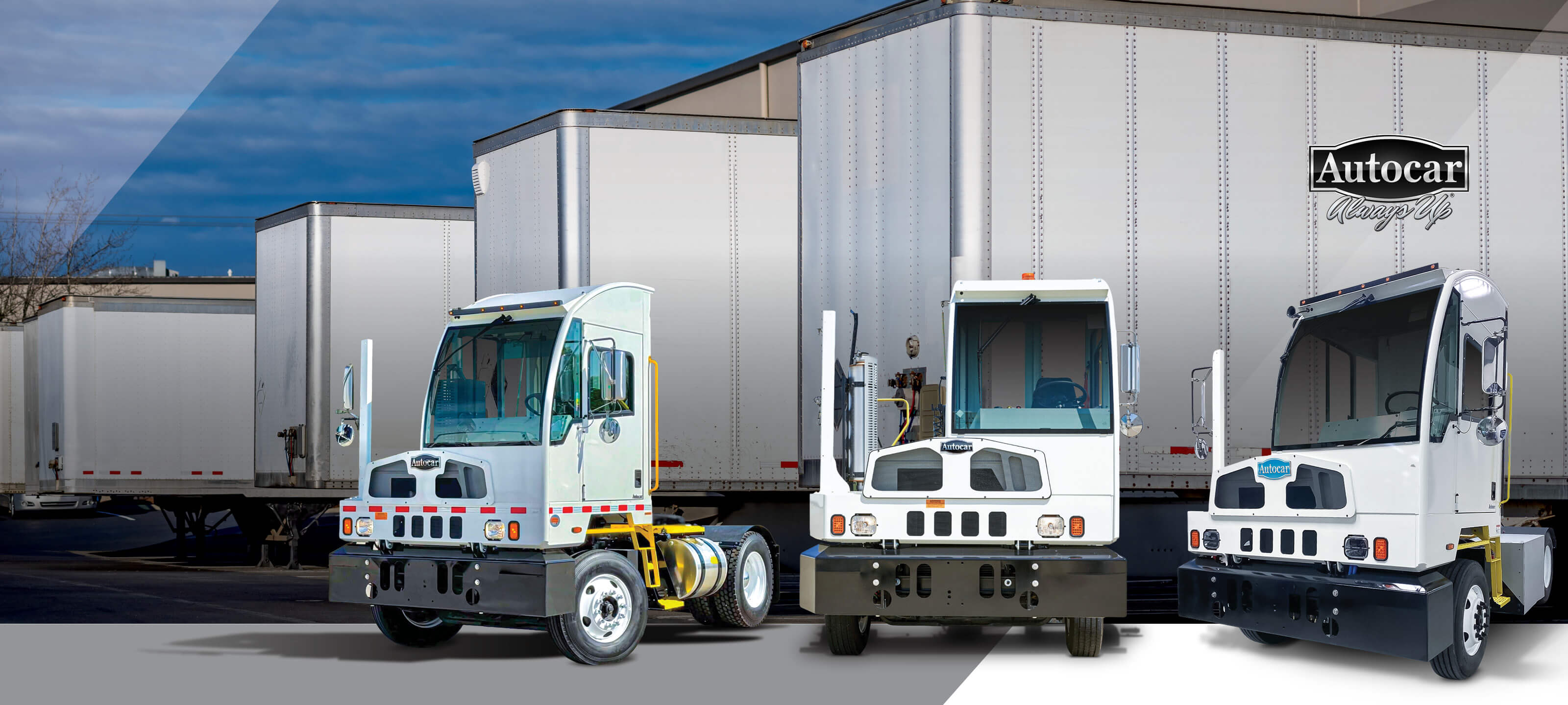 Line up of Autocar ACTT terminal tractors in front of semi trailers