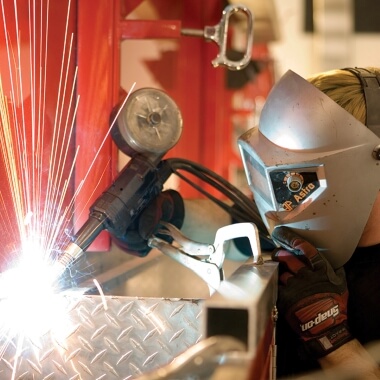 Body shop technician welding 