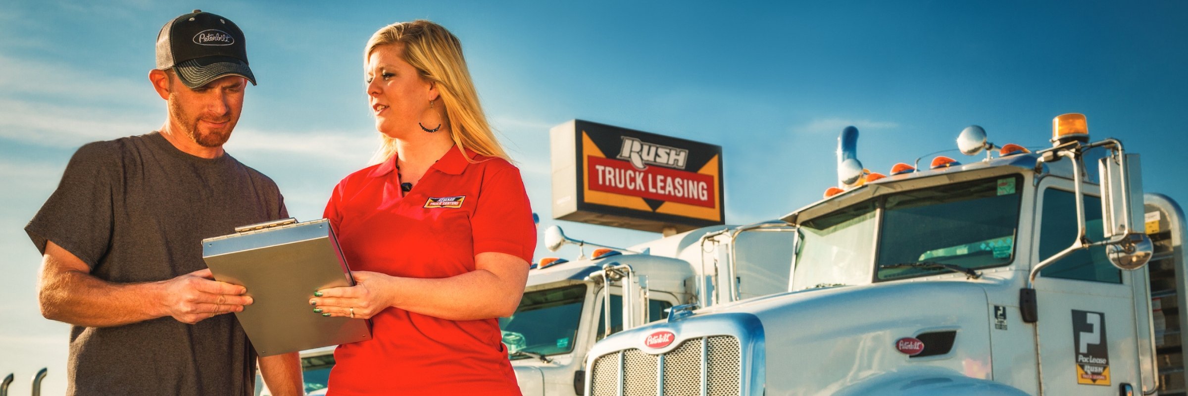 Rush Truck Leasing employee talking with customer on truck lot