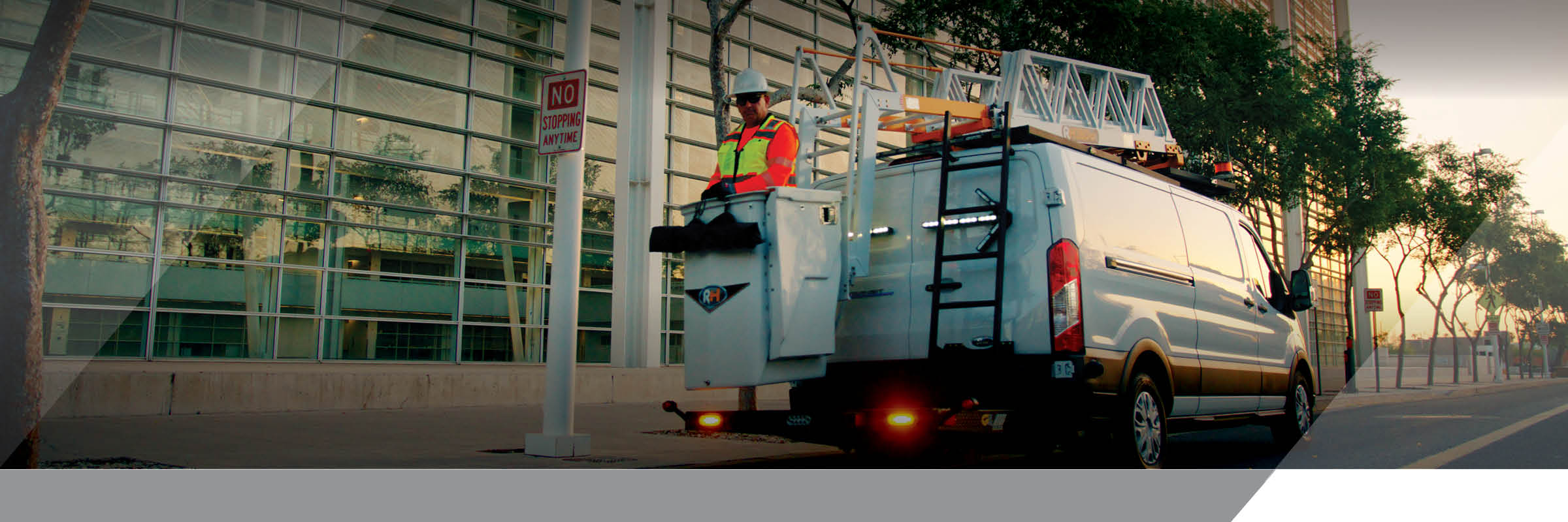 Utility worker in Lift Up bucket lift on Ford Transit