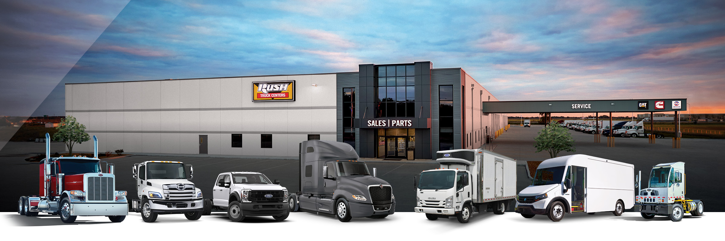 Line up of commercial vehicles from Peterbilt, International, Hino, Isuzu, Ford, Autocar and Blue Arc