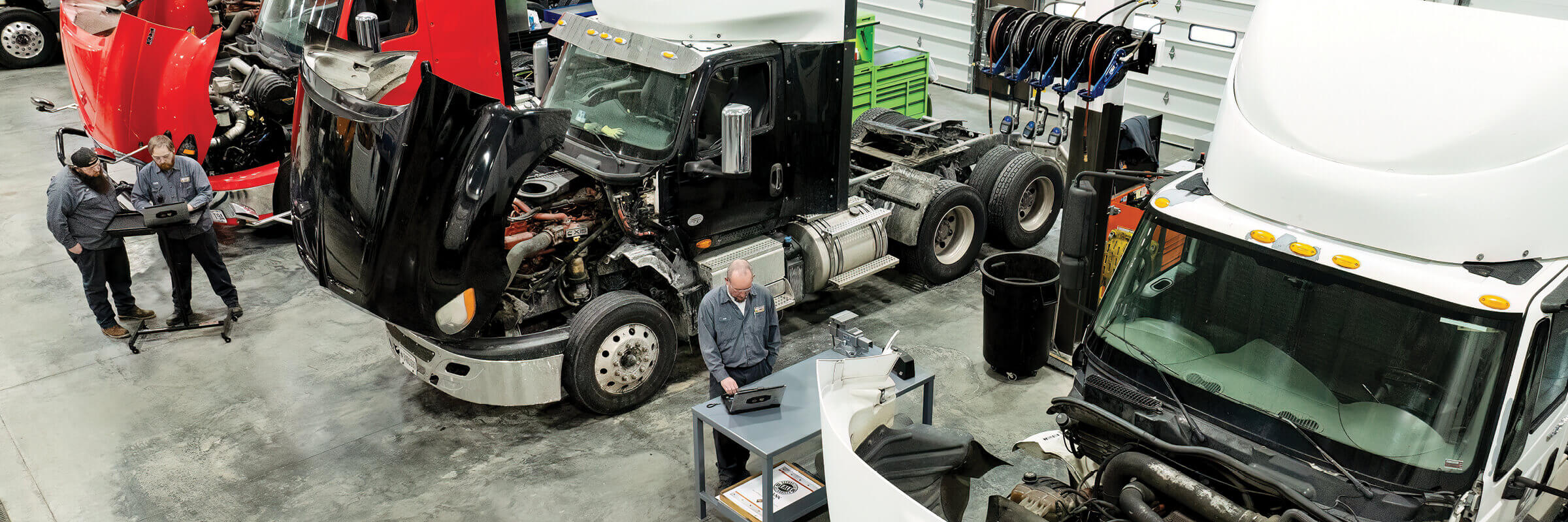 Rush Truck Centers mechanics working on trucks in service bays