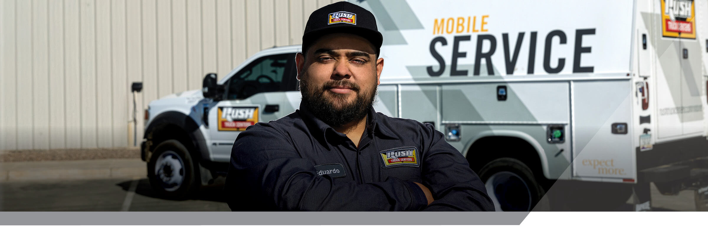Rush Truck Centers mobile service technician standing in front of mobile service truck